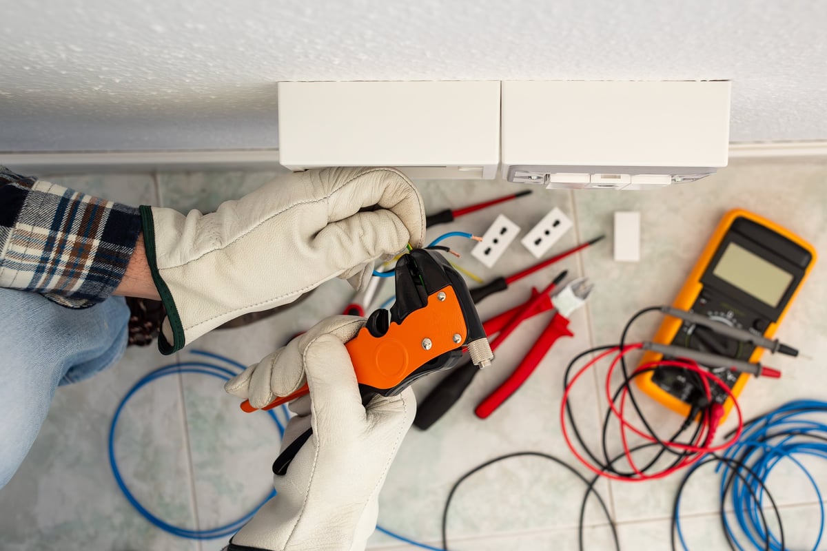 Professional electrician working safely with electrical wires